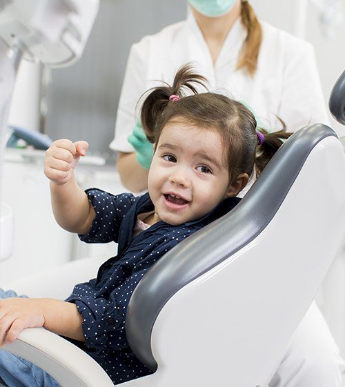 Little girl in dental chair for lip and tongue tie treatment