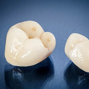A closeup of two ceramic dental crowns