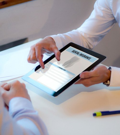Showing a patient a dental insurance form on a tablet