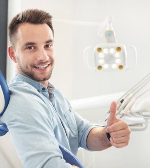 man giving thumbs up at his cosmetic dentist in North Grafton 