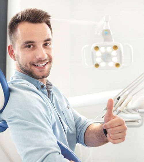 man giving a thumbs up in the dental treatment chair
