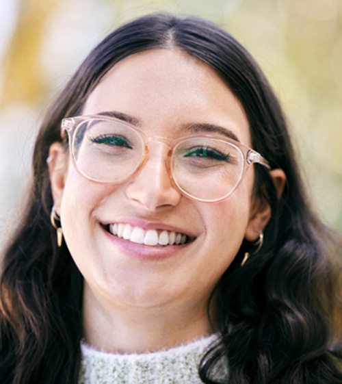 a smiling woman with glasses 