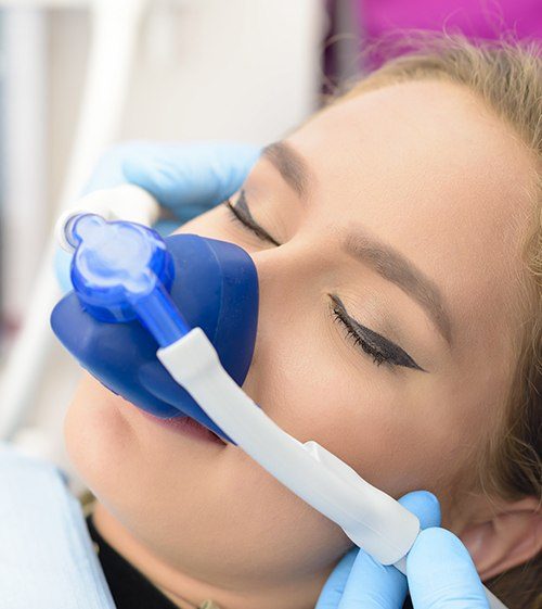 Woman with nitrous oxide dental sedation mask in place
