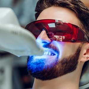 Male dental patient undergoing in-office teeth whitening in North Grafton, MA
