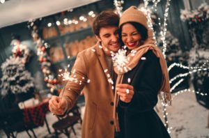 couple celebrates new year's with sparklers 